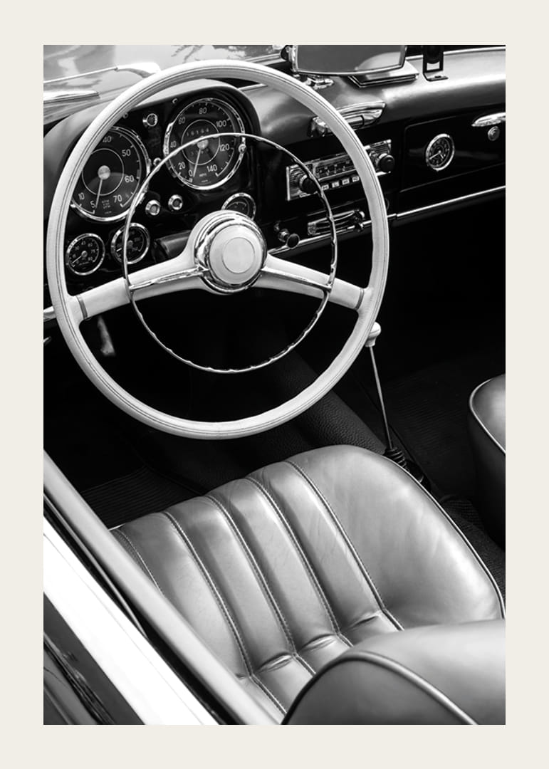 Black and white close-up of classic car interior with steering wheel-12