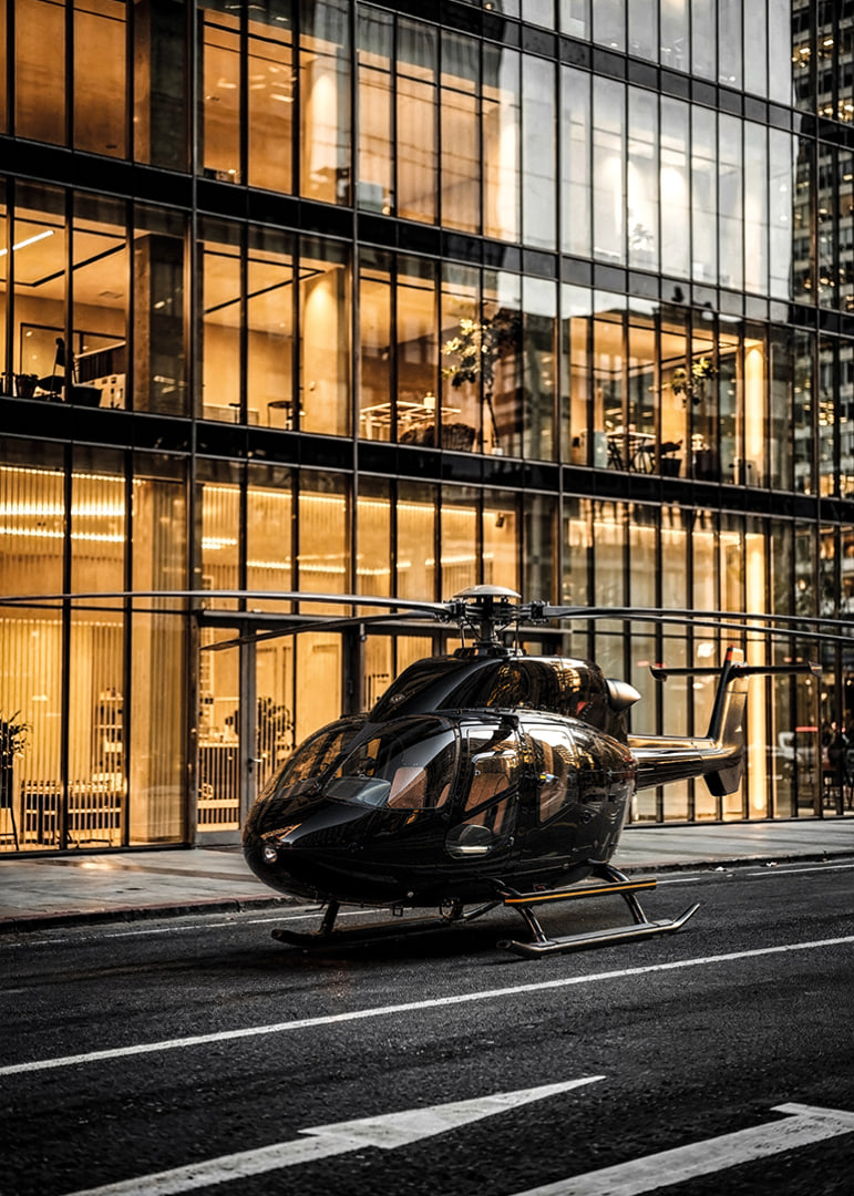 Black helicopter on city street in front of glass facade in evening light-12