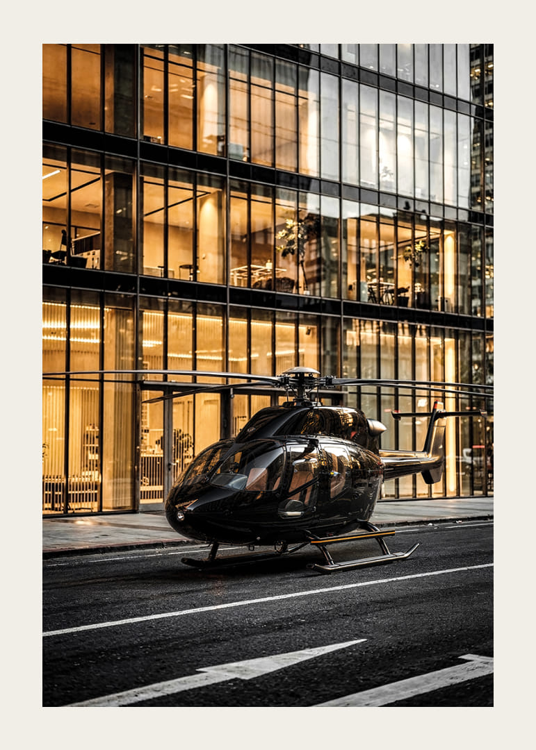 Black helicopter on city street in front of glass facade in evening light-12