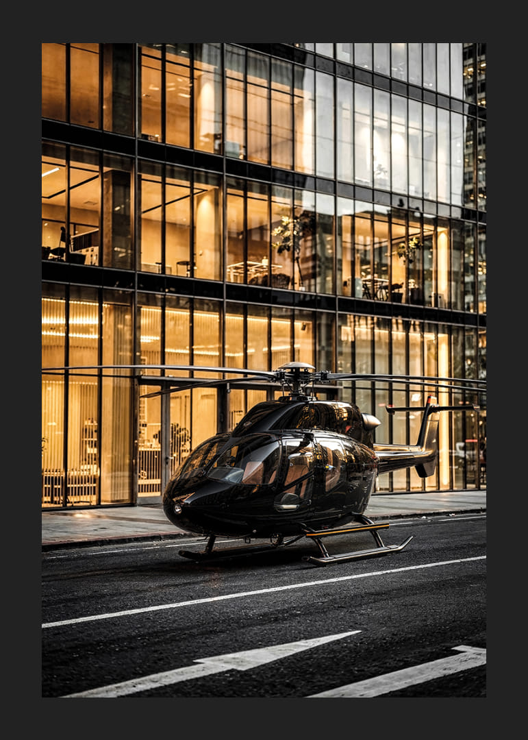Black helicopter on city street in front of glass facade in evening light-12