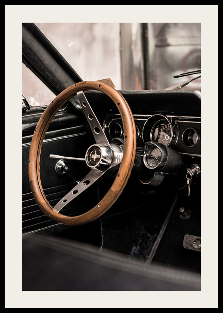 Photograph of classic car interior with wooden steering wheel in focus-12