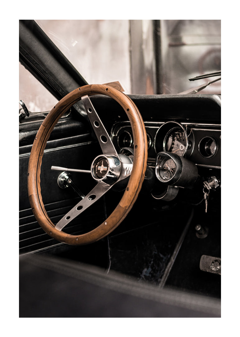 Photograph of classic car interior with wooden steering wheel in focus-12