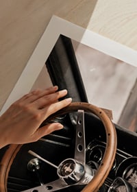 Photograph of classic car interior with wooden steering wheel in focus-9