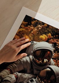 Two astronauts lying in field of orange and yellow flowers-9