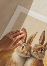 Illustrated bunnies next to daisies and painted Easter eggs-9