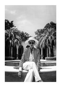 Black and white photo of woman in suit and sun hat by pool-1