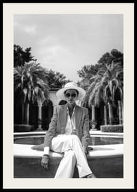 Black and white photo of woman in suit and sun hat by pool-2