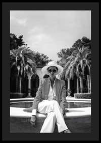 Black and white photo of woman in suit and sun hat by pool-4