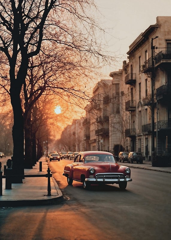 Photograph of red vintage car on city street in soft evening light-12