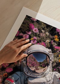 Astronaut in spacesuit surrounded by pink and yellow flowers-9