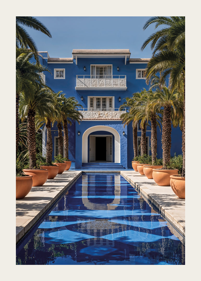 Photograph of blue villa with palm trees and long swimming pool in the foreground-12