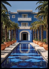 Photograph of blue villa with palm trees and long swimming pool in the foreground-6