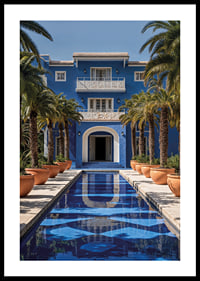 Photograph of blue villa with palm trees and long swimming pool in the foreground-0
