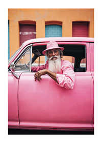 Elderly man with long beard in pink car in front of colorful facade-1