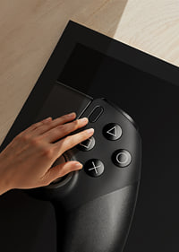 Close-up of black game controller with matte black background-9