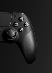 Close-up of black game controller with matte black background-7