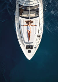 Aerial view of woman in white swimsuit on luxury yacht over turquoise sea-7
