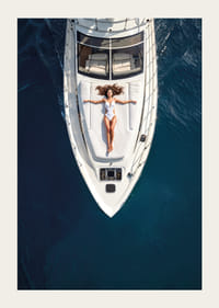 Aerial view of woman in white swimsuit on luxury yacht over turquoise sea-3