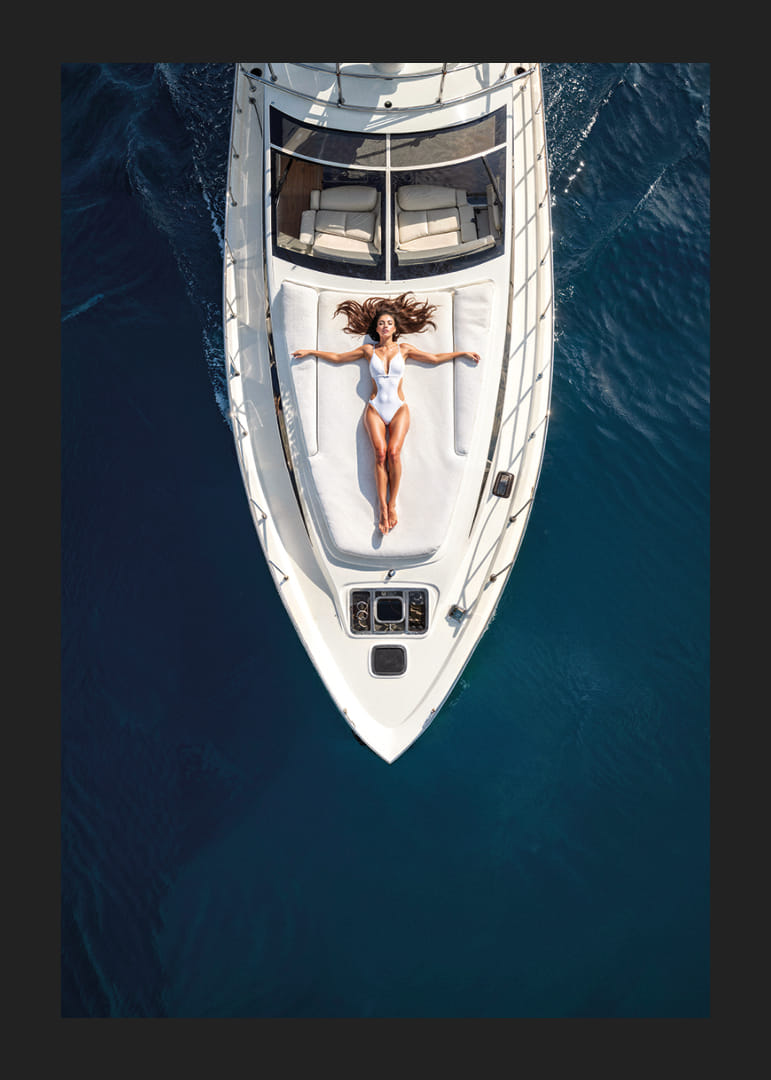 Aerial view of woman in white swimsuit on luxury yacht over turquoise sea-12