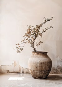 Photograph of rustic clay pot with flowering twig in soft beige tones-7