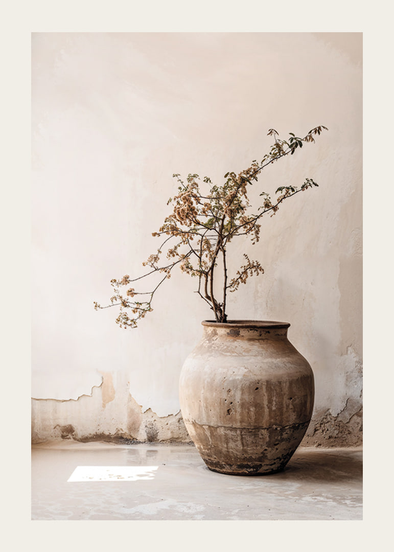 Photograph of rustic clay pot with flowering twig in soft beige tones-12