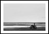 Black and white poster with a photograph of a lone motorcycle on a deserted beach-0