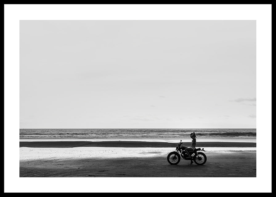Black and white poster with a photograph of a lone motorcycle on a deserted beach-12