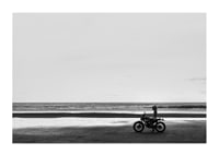 Black and white poster with a photograph of a lone motorcycle on a deserted beach-1