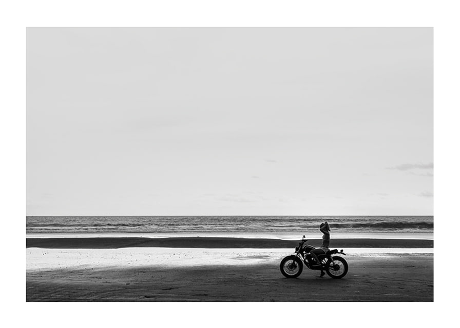 Black and white poster with a photograph of a lone motorcycle on a deserted beach-12