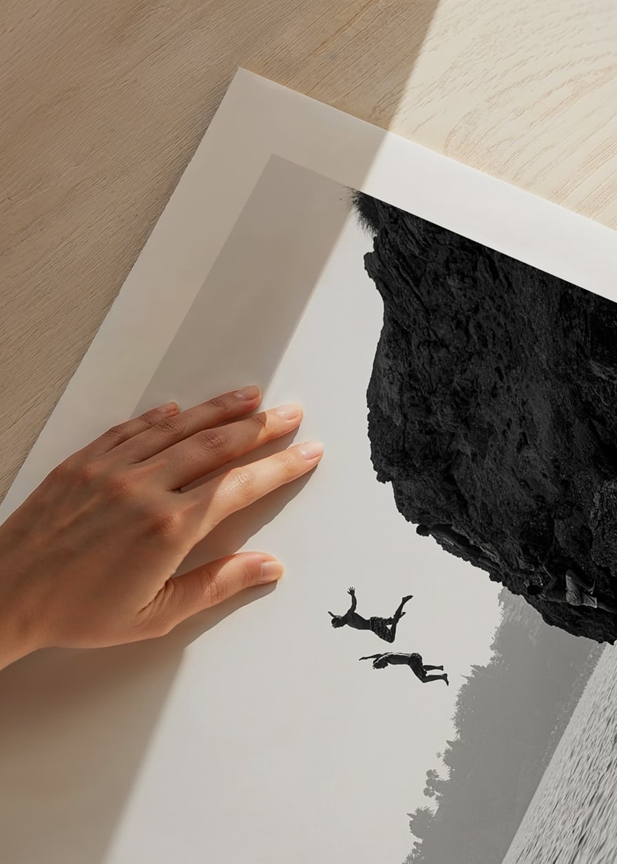 Black and white poster with a photograph of two people jumping from a cliff into the sea-12