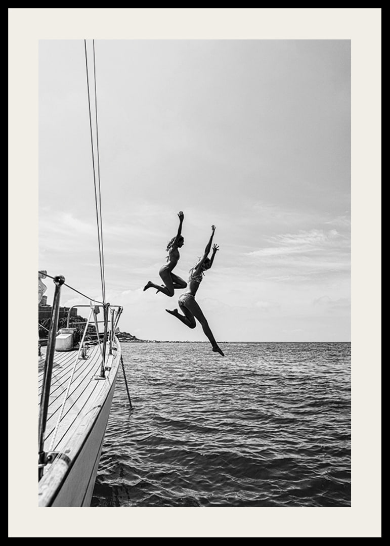 Black and white poster with a photograph of two people jumping from a sailboat into the sea-12