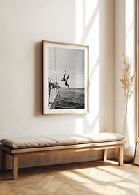 Black and white poster with a photograph of two people jumping from a sailboat into the sea-8