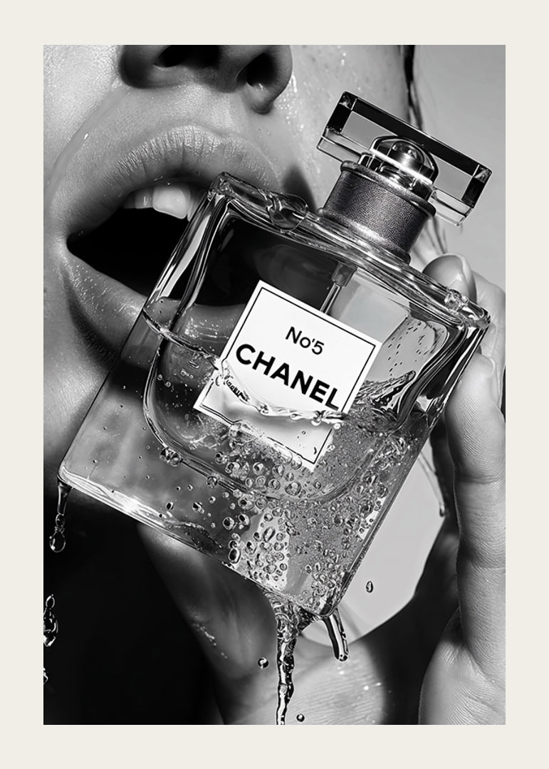 Black and white poster with a sensual photograph of a woman holding a Chanel No5 perfume bottle-12