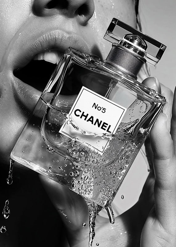 Black and white poster with a sensual photograph of a woman holding a Chanel No5 perfume bottle-12