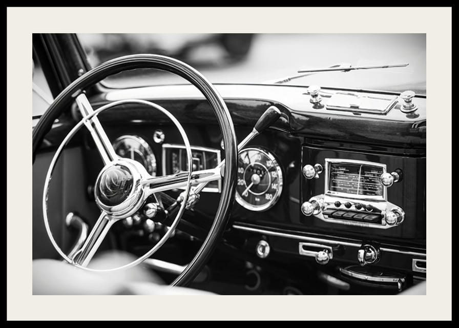 Black and white poster with a photograph on the dashboard of a classic car-12