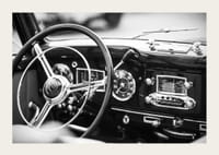 Black and white poster with a photograph on the dashboard of a classic car-3