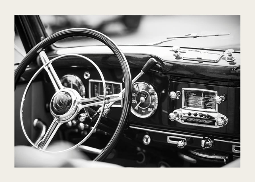 Black and white poster with a photograph on the dashboard of a classic car-12