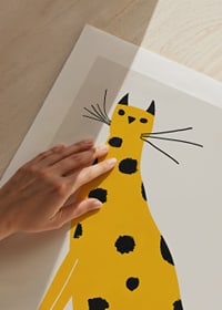 Poster with a painting of a yellow cat with black spots-9