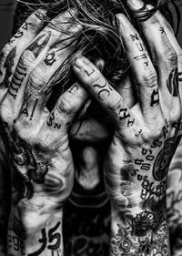 Black and white poster with a photograph of a man with his face hidden in his tattooed hands-7
