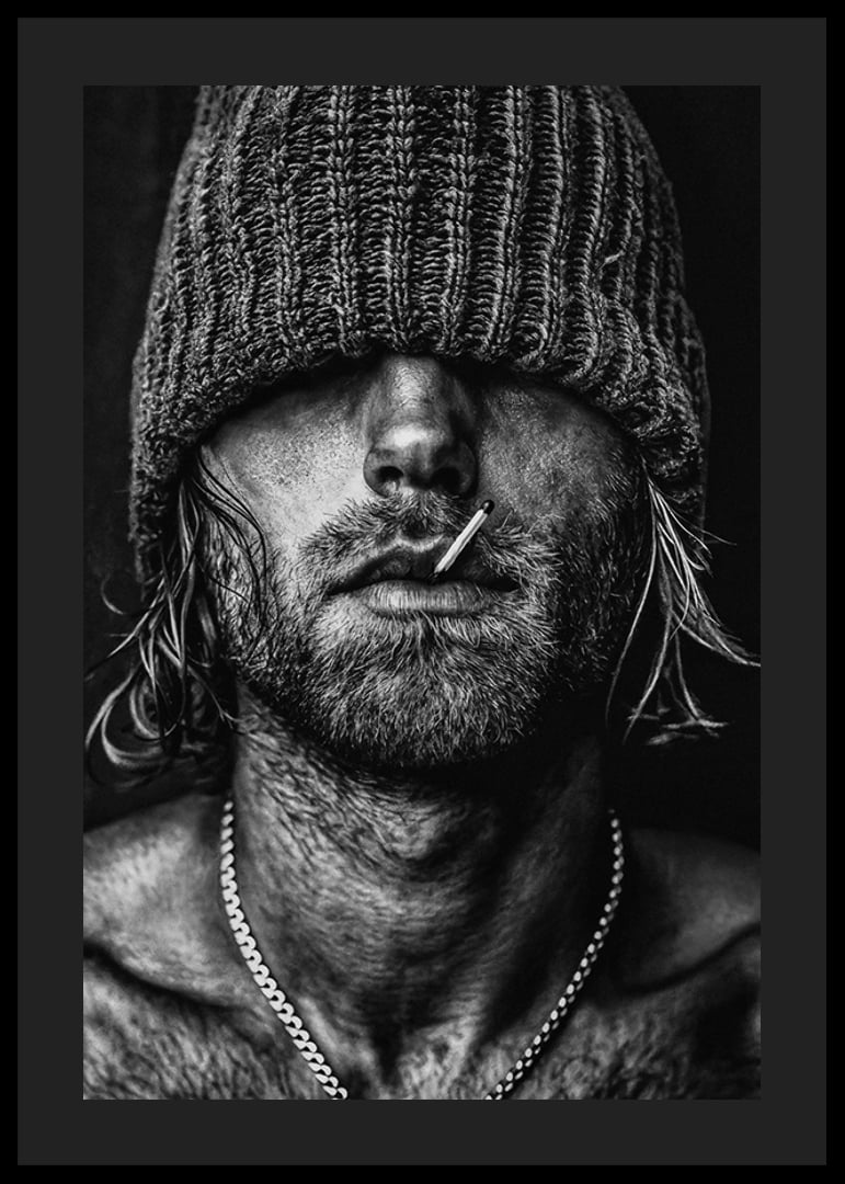 Black and white poster with a photograph of a man with a cap pulled down over his eyes-12