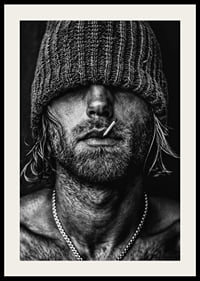 Black and white poster with a photograph of a man with a cap pulled down over his eyes-4