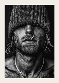 Black and white poster with a photograph of a man with a cap pulled down over his eyes-5