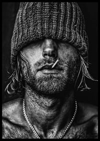 Black and white poster with a photograph of a man with a cap pulled down over his eyes-6