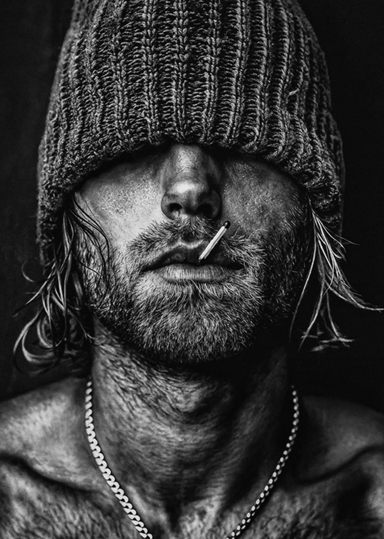 Black and white poster with a photograph of a man with a cap pulled down over his eyes-12