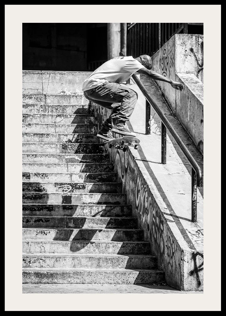 Black and white poster with a photograph of a skateboarder jumping down a flight of stairs-12