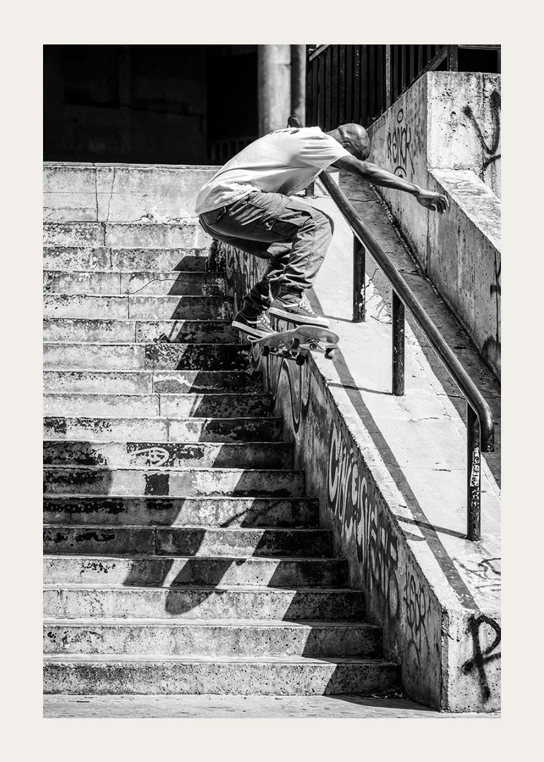Black and white poster with a photograph of a skateboarder jumping down a flight of stairs-12