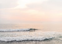 Poster with a photograph of a lone surfer at sea among the waves-7