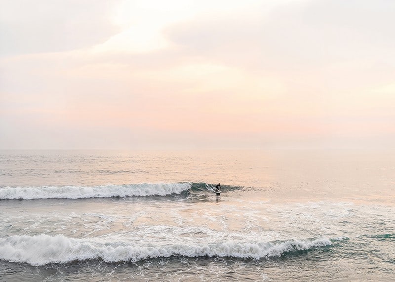 Poster with a photograph of a lone surfer at sea among the waves-12