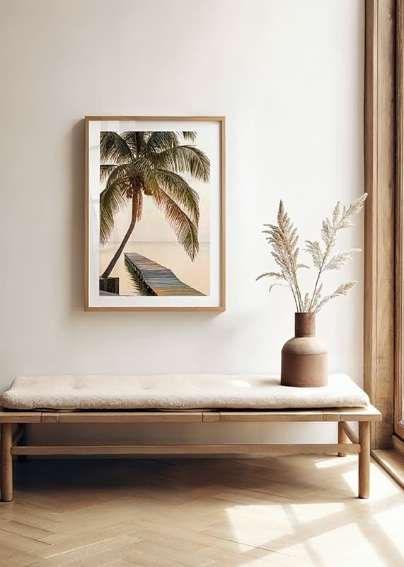 Poster with a photograph of a jetty in the sea under a palm tree at sunset-12
