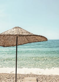 Poster with a photograph of a beautiful parasol by a beach-7
